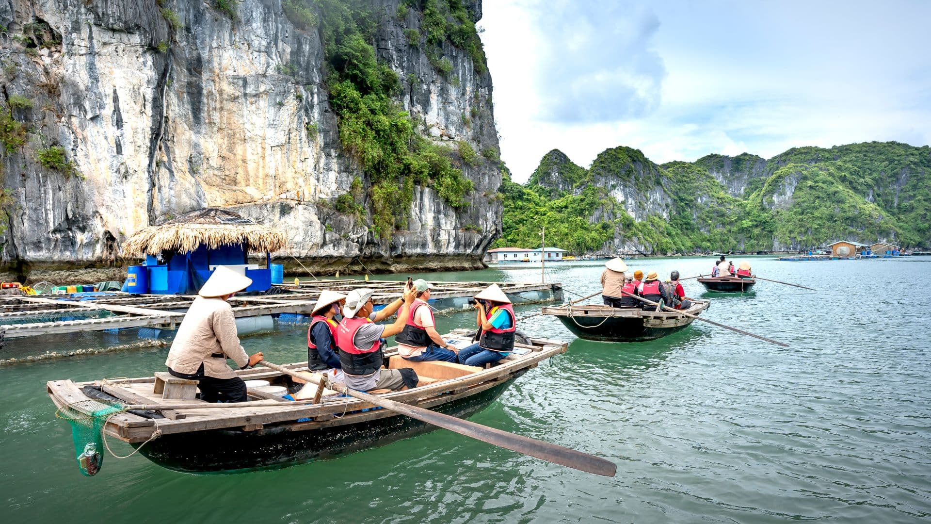 A sampan boat ride through Tam Coc’s caves offers a peaceful journey along winding rivers, limestone karsts, and lush rice paddies, rowed by locals using their hands or feet.