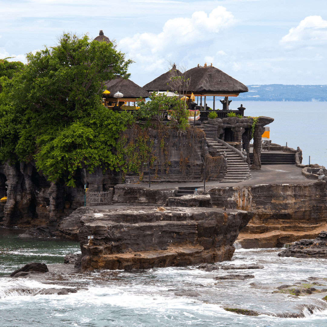 visit the world-famous Tanah Lot Temple, set against a dramatic coastal backdrop.